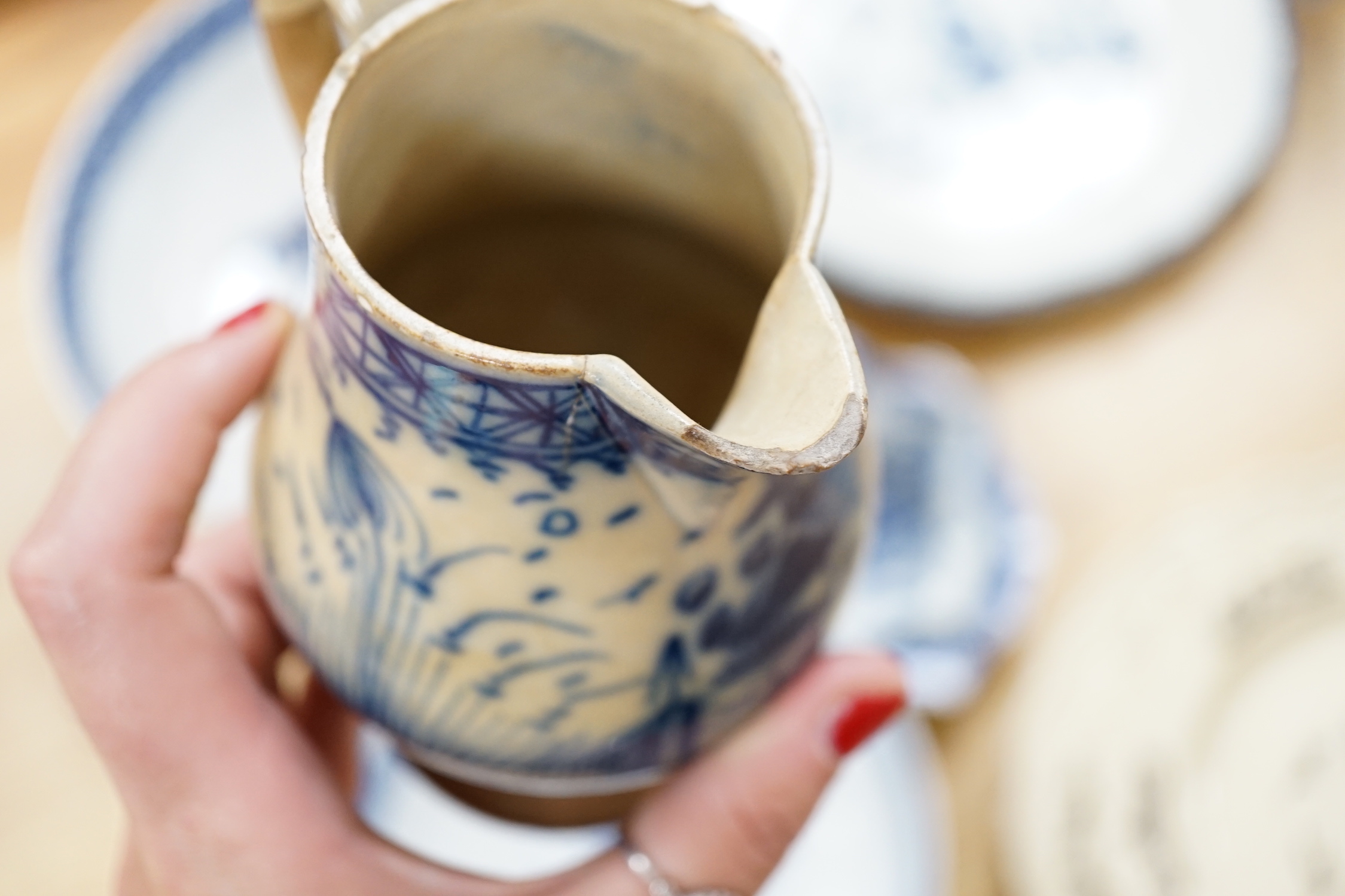A collection of late 18th/early 19th century pearlware and creamware including three black transfer printed creamware plates, c.1780, blue and white bowls, plates, dishes and jug, the largest 27cm in diameter